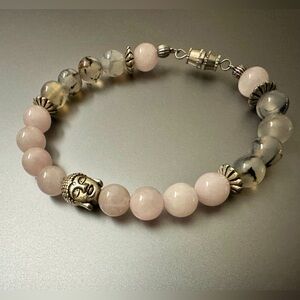 Natural stone bracelet with Buddha head. Pink and smoky, with silver accents.